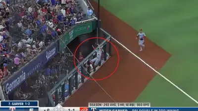 Zach Neto leaps against a fence