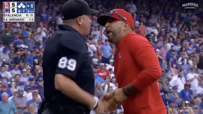 Oliver Marmol argues with an umpire