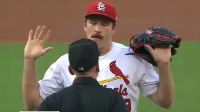 Miles Mikolas holds up his hands