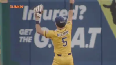 A Savannah Bananas player makes a catch while doing a backflip