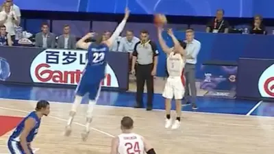 Yuki Kawamura hits a shot over Lauri Markkanen