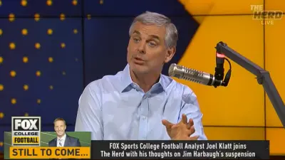 Colin Cowherd in front of a microphone