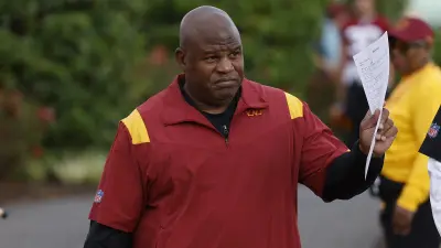 Eric Bieniemy waving to fans