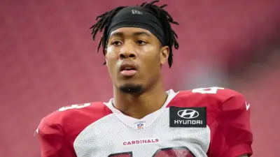 Isaiah Simmons watches from the sideline