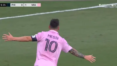 Lionel Messi with his arms out