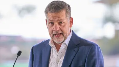 Mike Golic speaking at a podium