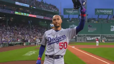 Mookie Betts holds up his arm