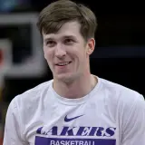 Austin Reaves smirking while wearing a Lakers shirt