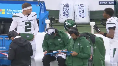 Garrett Wilson and Zach Wilson get into it on the sideline