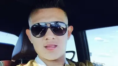Julio Urias poses in a car