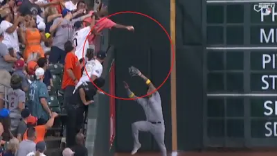 A fan reaches over