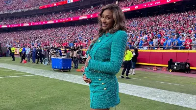 Maria Taylor holds her baby bump