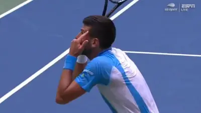 Novak Djokovic points to his head
