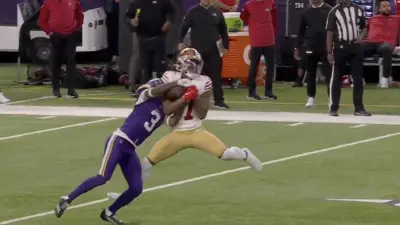 Jordan Addison taking the football from Charvarius Ward during Vikings-49ers