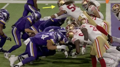 49ers' Fred Warner diving to stop a QB sneak from Vikings' Kirk Cousins