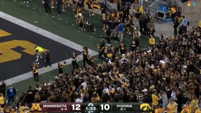 Iowa fans throwing trash on the field