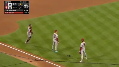 Diamondbacks players stand on infield
