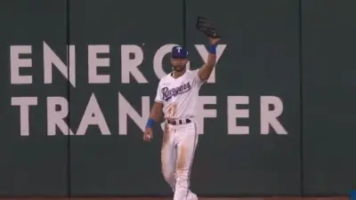Leody Taveras holding up his glove