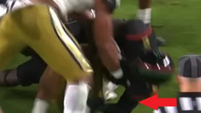 A Miami player has his elbow down