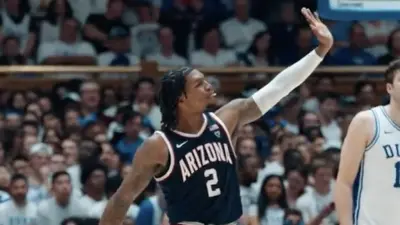 Arizona guard Caleb Love waves goodbye to Duke fans
