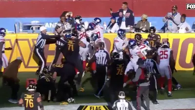 Giants and Commanders players fight after a touchdown