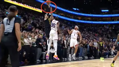 Kevin Durant contesting Lauri Markkanen's shot during a Suns-Jazz game