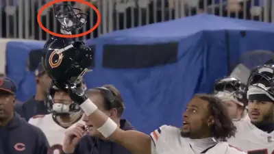 Bears cornerback Kyler Gordon holding up his helmet