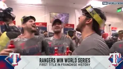 Rangers players celebrate in the clubhouse