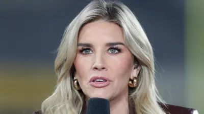 Charissa Thompson holds a mic