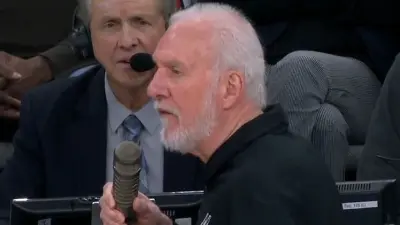 Gregg Popovich holding a microphone