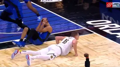 Nikola Jokic and Jalen Suggs on the floor