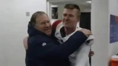 Bailey Zappe and Bill Belichick share a hug