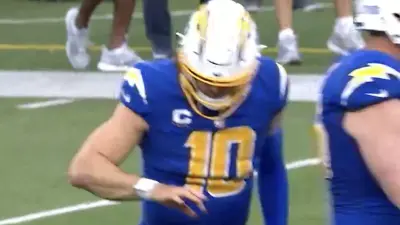 Justin Herbert inspects his finger injury