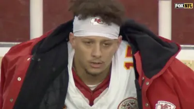 Chiefs QB Patrick Mahomes looking frustrated while sitting on the sideline