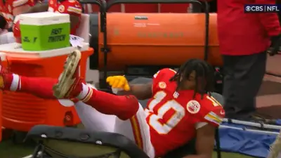 Isiah Pacheco falls through a table