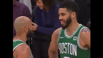 Jayson Tatum talks with Derrick White