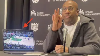 Kings coach Mike Brown with a laptop