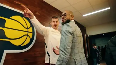 Nikola Jokic standing next to Andre Iguodala