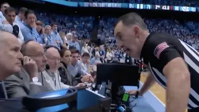 A ref talks to the scorers table