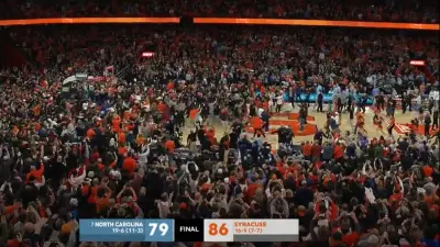 Syracuse fans storm the court after beating North Carolina