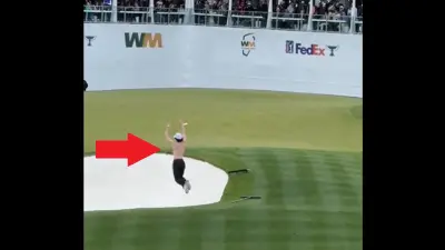 Fan jumps into a bunker at the Waste Management Phoenix Open's 16th hole