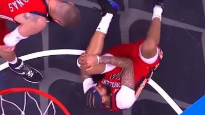 Brandon Ingram grabs his knee in pain