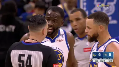 Draymond Green arguing with a referee while Steph Curry looks on