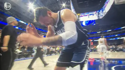 Mavericks star Luka Doncic looking shocked after a Kyrie Irving game-winner to beat the Nuggets for a Mavs win