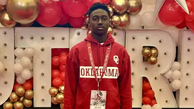 Nelson Peterson Jr in front of an Oklahoma banner