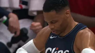 Russell Westbrook looks at his hand