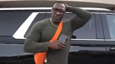 Shannon Sharpe outside his car