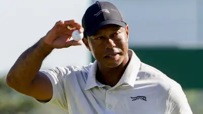 Tiger Woods holds his ball up