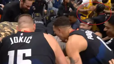 Anthony Davis being helped up by Kentavious Caldwell-Pope