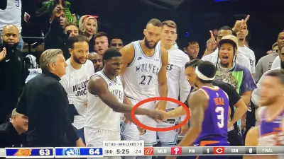 Anthony Edwards dapping up NBA referee Zach Zarba during Game 2 of Suns-Timberwolves